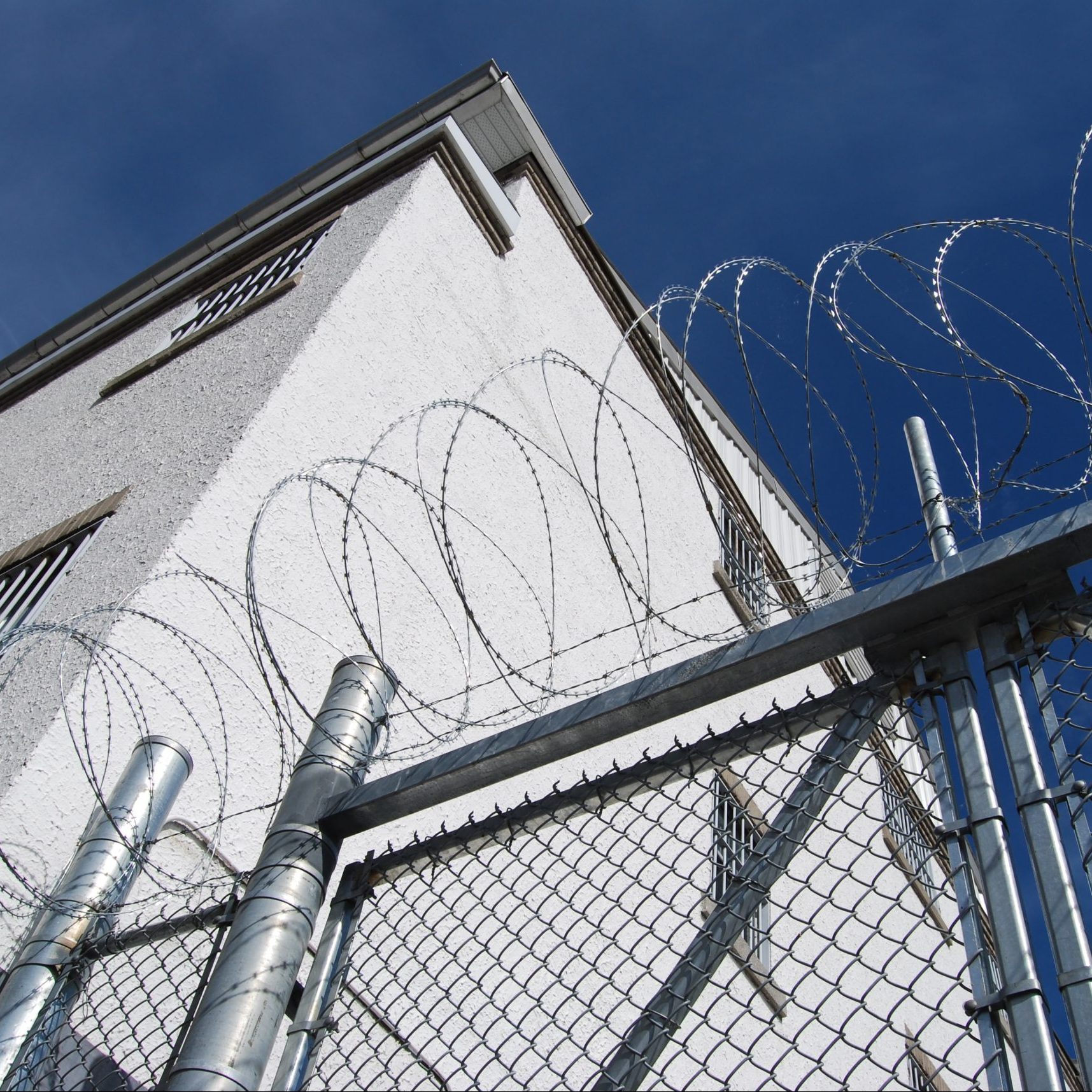Prison building with barbed wire and fence