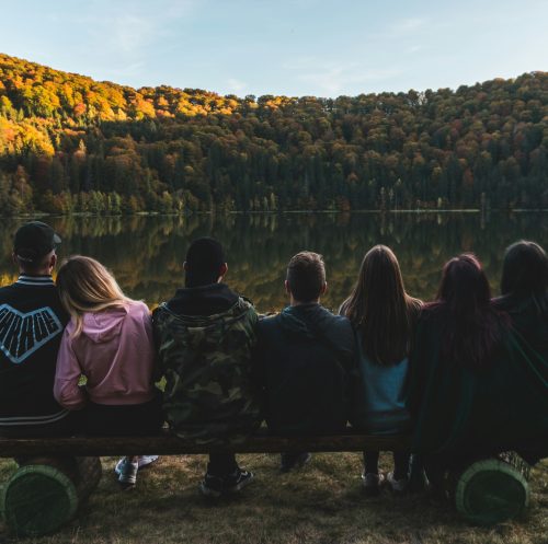 Young people looking at lake